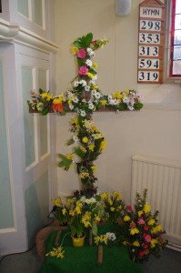 On Easter Morning the empty cross is decorated with flowers by the congregation during the singing of the first hymn